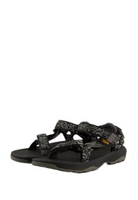 Black and gray patterned sandals with adjustable straps, rubber sole, and cushioned footbed. Suitable for outdoor activities.