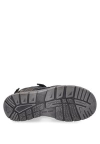 Czarna teksturowana podeszwa buta z wzorzystym bieżnikiem, z kątowymi rowkami i wzmocnioną częścią pięty. Widoczny rzep na górnej części.