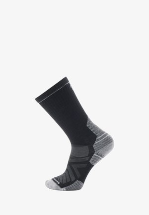 Black and gray athletic sock with a ribbed upper, reinforced heel, and zigzag pattern at the toe. Made of breathable material.