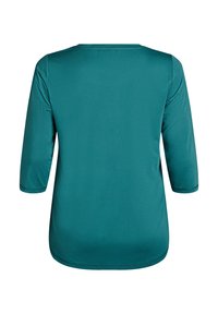 Tyrkysové, dlhé rukávy tričko s hladkou textúrou a okrúhlym výstrihom. Žiadne viditeľné vzory ani kovania; má voľný strih.