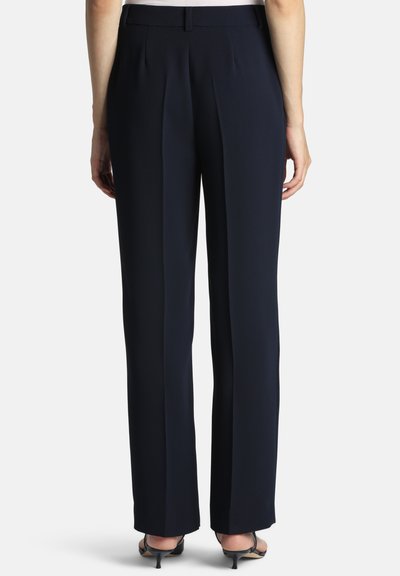 Dark navy trousers with a tailored fit, featuring front pleats, a smooth texture, and a straight leg design, completed with a discreet waistband.