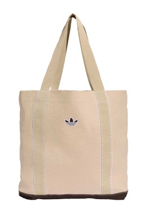 Beżowa torba na ramię z płótna z dwoma długimi uchwytami, białymi przeszyciami, ciemnobrązowym dolnym brzegiem oraz małym czarno-białym logo Adidas.