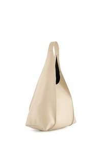 Beżowa skórzana torba hobo z pojedynczym uchwytem, gładką teksturą, miękką sylwetką i otwartą górą. Czarny środek jest widoczny z boku.