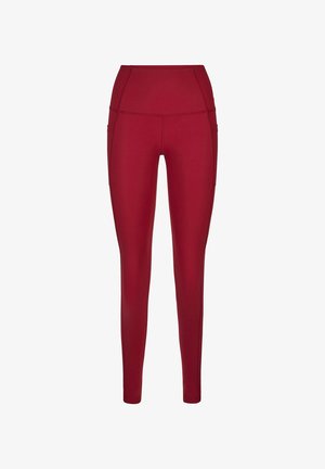 High-waisted, full-length burgundy leggings with side pockets and stitched seam details, designed for activewear.