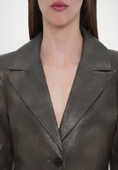 Gray leather jacket with a notch lapel, button closure, and a smooth texture. Close-up view highlights stitching and collar details.