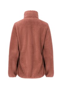 Fleece-takki, jossa on teksturoitu, ruosteenvärinen pinta ja korkeakauluksinen zigzag-kuvio. Ominaisuuksina pitkät hihat ja rento leikkaus. Takaa otettu kuva.