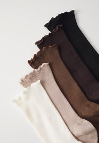 Set van vijf kniekousen in verschillende kleuren: zwart, donkerbruin, lichtbruin, beige en wit. Ribbel-textuur met golvende bovenkanten.