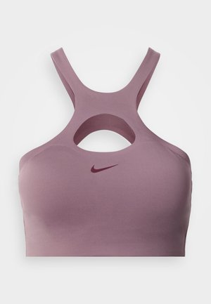 Lilla spordirinnahoidja lõigatud disaini ja risti rihmadega. Pehme kangas sileda tekstuuriga, esiküljel väike burgundia logo.