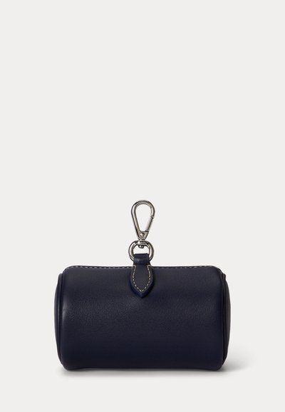 Small navy blue leather pouch with cylindrical shape, white stitching, and silver metal clasp hook on top for attachment.