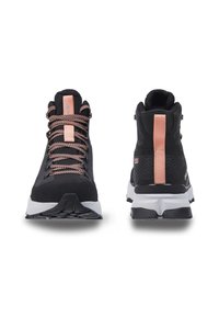Black hiking shoes with textured fabric, pink accents, and prominent lacing. Features a cushioned white sole and a reinforced heel.