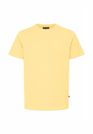 Dzeltena īsām piedurknēm T-kreklu, kas izgatavots no kokvilnas, ar apaļu kaklu, taisnu piegriezumu un mazu logo etiketi apakšmalā. Mīksta tekstūra.