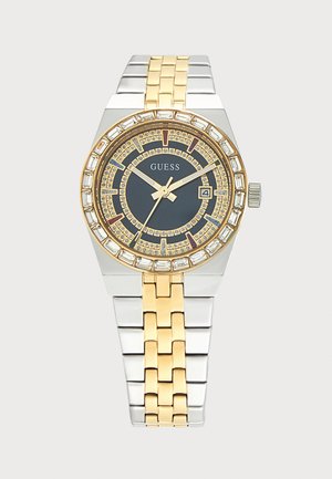Двуцветен сребърен и златен часовник Guess с тъмен циферблат, кристални индикатори за часове и дисплей за дата на 3 часа.