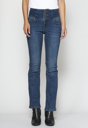 High-waisted dark blue jeans with a five-button closure, decorative stitching, and back pockets. Material has a standard denim texture.