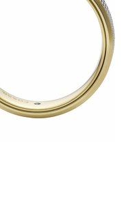 Gold-tone metal bracelet with smooth surface and textured accents. Features a thin, circular design and engraved logo detail.