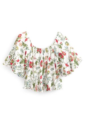 Witte cropped blouse met brede pofmouwen, voorzien van een kleurrijk bloemenpatroon in rood, roze, blauw en groene tinten.