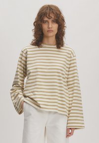 Gestreepte langemouwen shirt in crème en gedempte goud, met een relaxed fit en brede mouwen, gemaakt van zacht katoen.