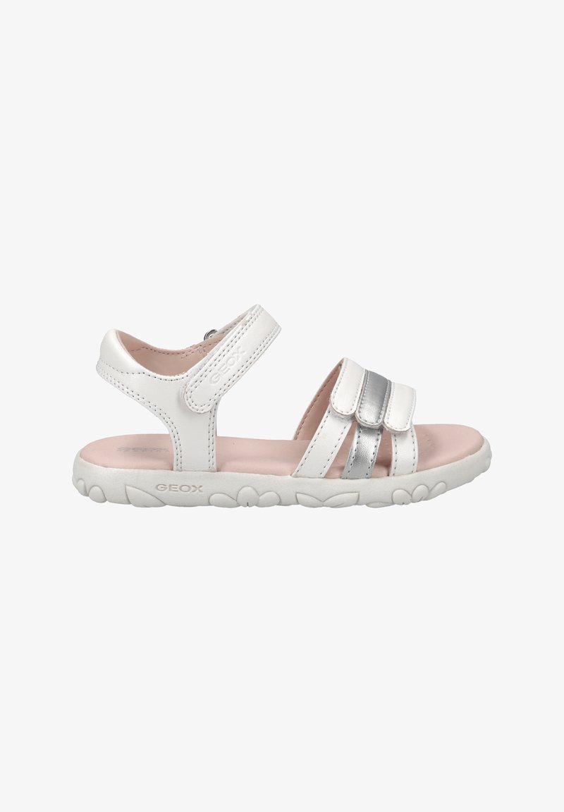 White sandals with silver accents, adjustable straps, soft pink insole, textured white outsole with floral pattern, made from breathable materials.
