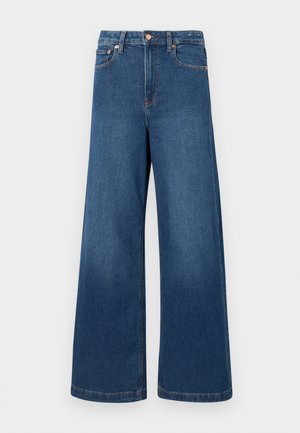 Tumedate värvi laiad teksapüksid. Omavad kõrget vööd, nööbikinnitust ja klassikalist viie tasku disaini kontrastset õmblustega.