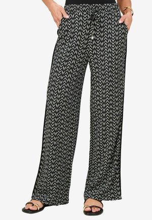 Pantaloni a palazzo a righe bianche e nere con vita elasticizzata, coulisse e tasche laterali, caratterizzati da un design a zigzag e un tessuto leggero.