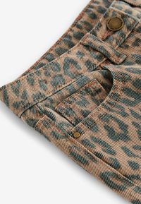 Leopardenmuster-Denim in einer beigen und grünen Farbgestaltung, mit einer Vorderasche und Metallschließe am Bund.