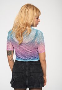 Sheer, short-sleeve top with a gradient of blue, pink, and purple hues. Features a geometric pattern and contrasting neckline trim.