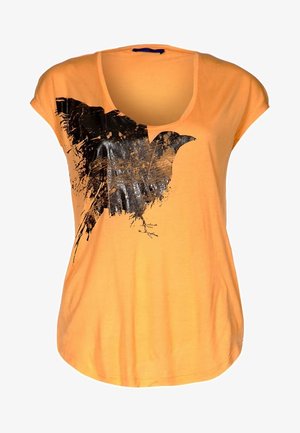 T-shirt orange à manches courtes avec un motif d'oiseau noir à effet usé, col large et coupe décontractée.