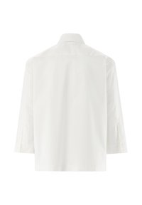 White long-sleeve shirt with a back collar, tailored fit, smooth fabric, side slits, and no visible fastenings or embellishments.
