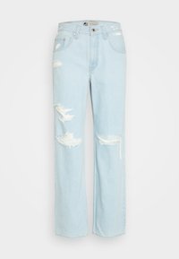 Lyseblå baggy jeans med slidte detaljer og store huller ved knæene. Har et traditionelt fem-lommers design og en knaplukning.