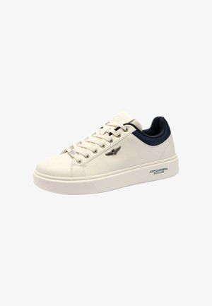 Sneaker in pelle bianca con punta arrotondata, suola piatta, dettagli navy e logo metallico. Presenta un design con lacci e suola testurizzata.