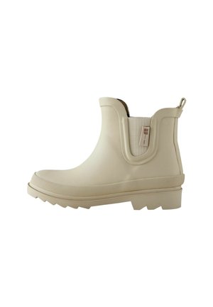 Botas de goma beige hasta el tobillo con una suela texturizada, paneles laterales elásticos y una lengüeta para ponérselas fácilmente. Acabado liso con punta redondeada.