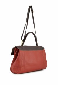 Leather handbag featuring a red body with a brown top flap, dual handles, and a long shoulder strap; smooth texture with visible stitching.