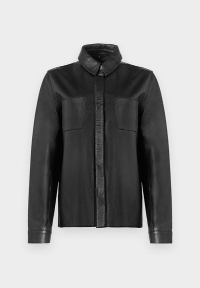 Black leather shirt jacket with a pointed collar, long sleeves, and two chest pockets. Smooth texture and button-down front design.