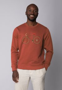 Rustkleurige sweatshirt van katoenmix, met een fietsafbeelding in bruin en rood. Ronde hals, lange mouwen en ribgebreide details bij de manchetten.