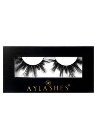 Black faux mink eyelashes in a clear tray, curved shape, varying lengths with feathery texture; packaged in a black box with gold branding.