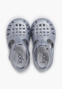 Gray plastic sandals with a woven design, open toe and heel, adjustable strap, and metallic interior detailing. Designed for comfort and breathability.