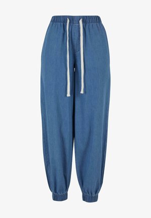 Jogger in denim con vita elastica e cordoncino. Colore azzurro chiaro, gamba affusolata con polsini elasticizzati, che mettono in risalto una texture liscia.