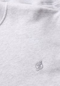 Gray sweatshirt fabric with a soft, textured surface. Features a subtle embroidered logo on the chest area. Ribbed neckline and hem.