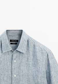 Light blue and white vertically striped linen shirt with collar and buttons, labeled Massimo Dutti, laid flat on white background.