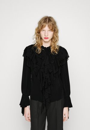 Blusa nera a maniche lunghe con dettagli arricciati lungo il davanti e il colletto, con polsini arricciati e un tessuto morbido e fluido.