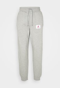 Grijze sweatpants van een zachte katoenmix. Voorzien van een elastische tailleband met trekkoord, zijzakken en een rood logo patch.