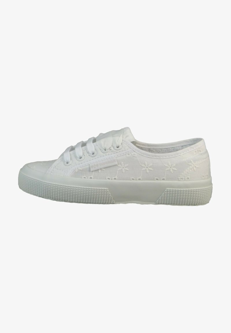 White canvas sneakers featuring embroidered floral patterns, round toe, six eyelets, and textured rubber sole for grip.