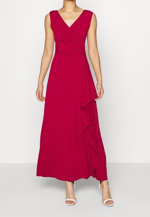Valkoinen maxi-mekko V-päällä, istuva yläosa ja valuvia sivuyksityiskohtia. Valmistettu pehmeästä kankaasta, sleeveless-muotoilu ja virtaava siluetti.