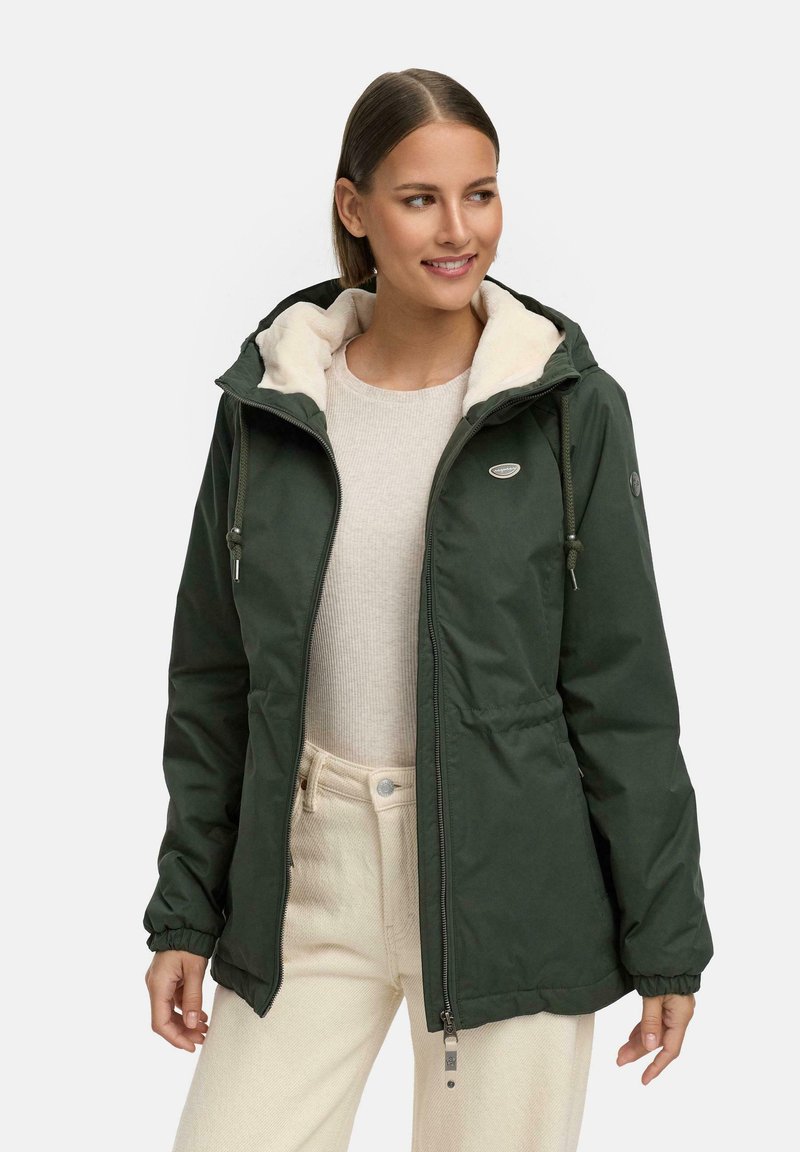 Dark green, padded jacket with a zip and drawstring hood, featuring a soft cream lining and side pockets. Adjustable cuffs complete the design.