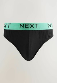 Svart kalsong med resår i mintgrön som har "NEXT" i svart text. Slät tyg, standard passform utan mönster.