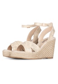 Sandalias de cuña beige con diseño de tiras cruzadas, fabricadas en tejido texturizado. El tacón de cuña envuelto en yute y la correa ajustable en el tobillo mejoran el soporte.
