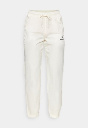 Cremfarbene, leichte Stoffhosen mit elastischem Bund und Kordelzug. Merkmale sind schmal zulaufende Beine und ein kleines schwarzes Logodetail.