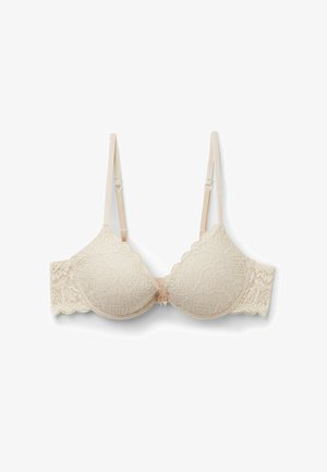 Beige krajková podprsenka s vlnkovanými okraji, s kosticemi, nastavitelnými ramínky a květinovým vzorem. Hladký povrch látky.