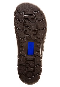Suola di scarpa in gomma marrone con un motivo di battistrada testurizzato, caratterizzata da un'etichetta blu e un logo in rilievo. Progettata per resistenza e trazione.