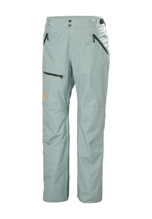 Pantalones impermeables de color azul claro con detalles en negro, dos bolsillos laterales con cremallera, un bolsillo en el muslo con cremallera y cinturilla ajustable.