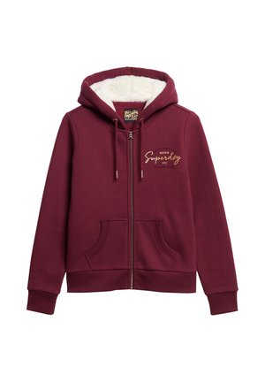 Bordowa bluza z kapturem na zamek z miękką białą polarową podszewką, przednimi kieszeniami, kapturem ze sznurkiem i złotym logo "Superdry NYC" na piersi.